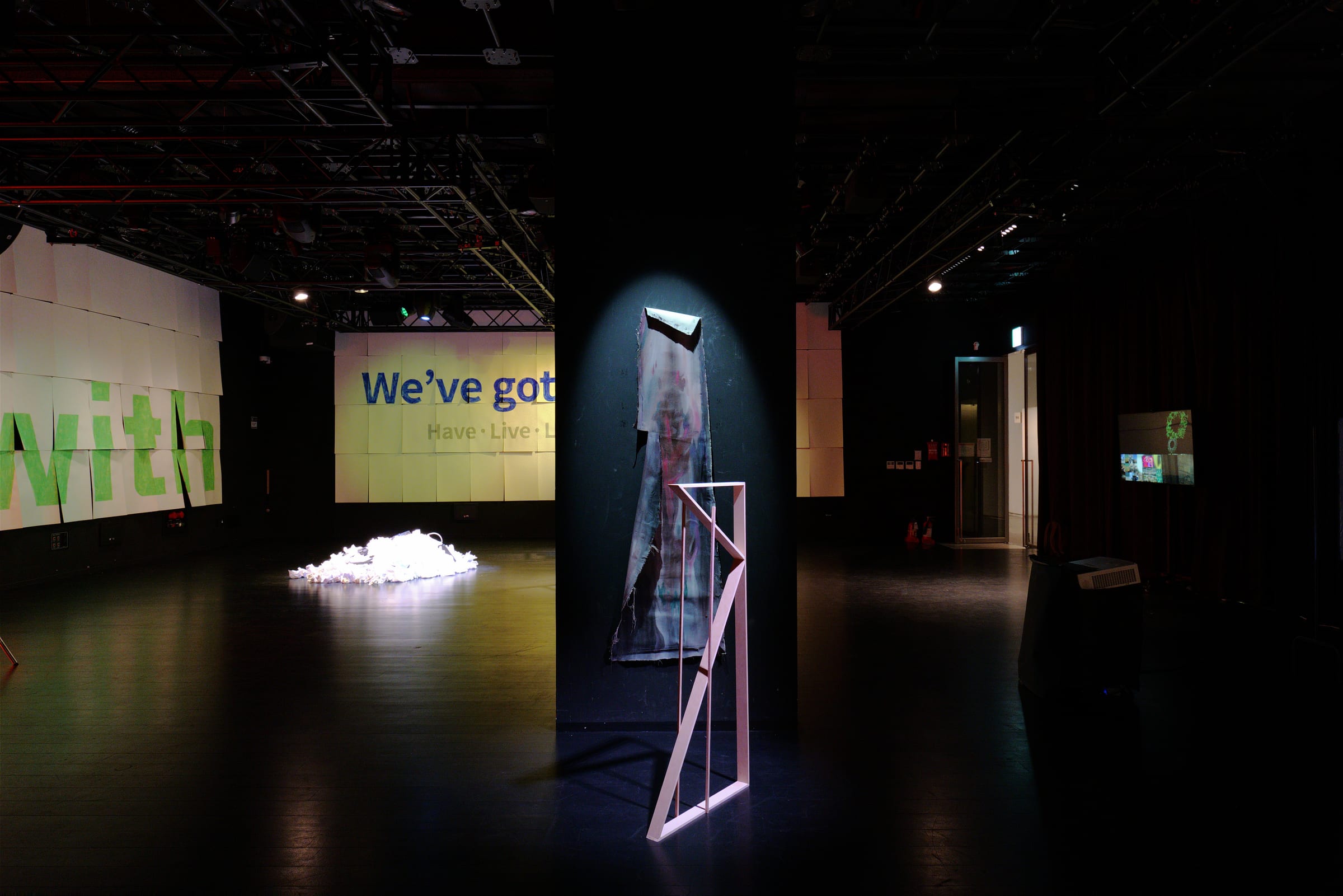 Hanging fabric work under a spotlight